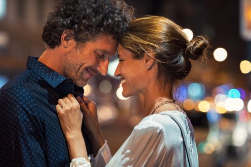 man and woman embracing in the street