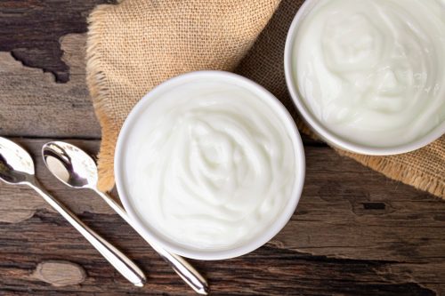 Yogurt In white glass wood background from top view.