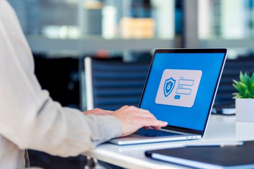 A close up of a person typing a password into a laptop