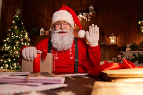 Saint Nicholas holding letter looking to camera,