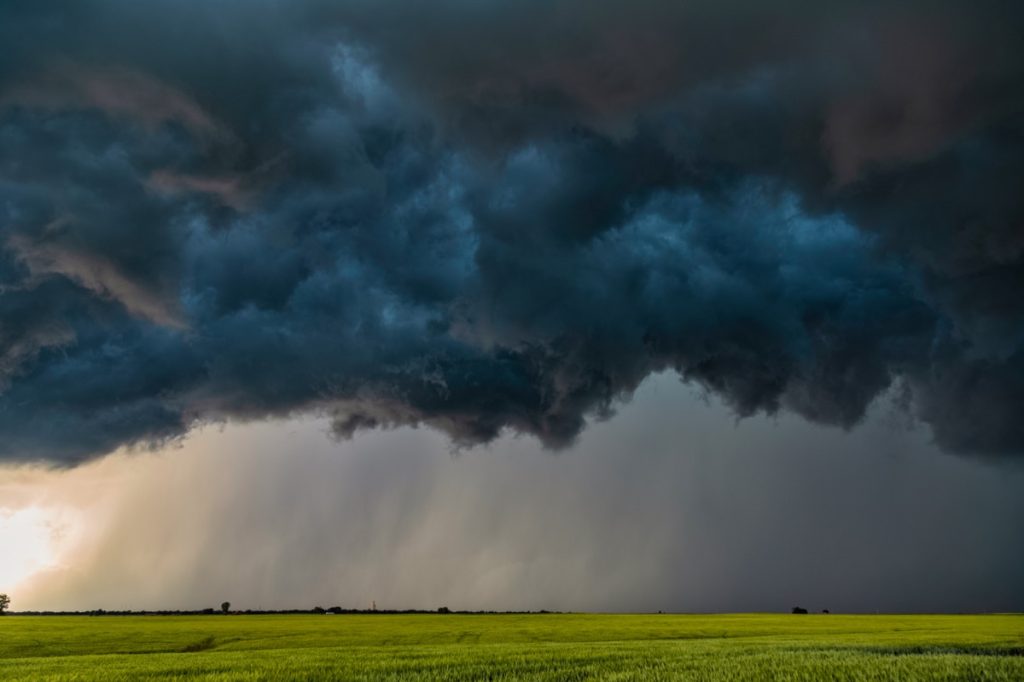 severe thunderstorm clouds over green field