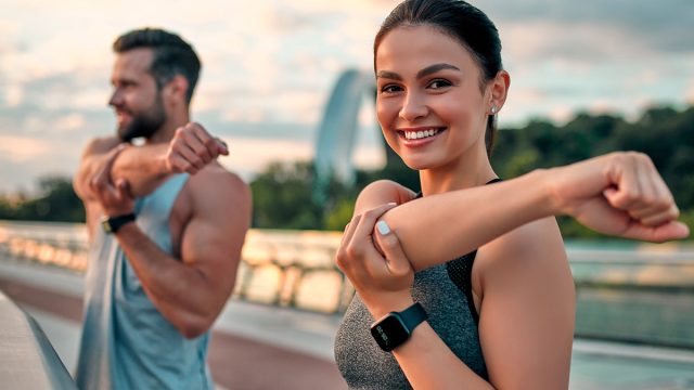Couple,Stretching,Outdoors,Before,Morning,Run.,Handsome,Bearded,Man,And