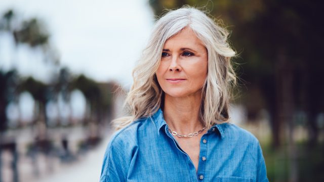 Beautiful fashionable mature woman with gray hair outdoors in the city