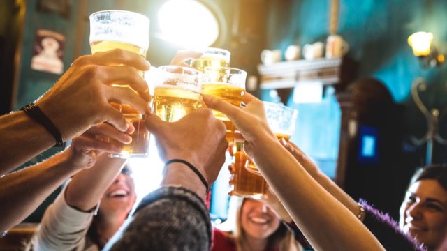 group of friends doing a toast at a bar