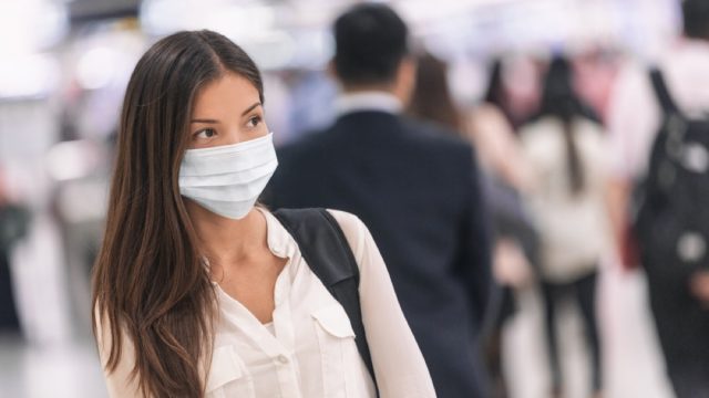 woman wearing a mask at the airport