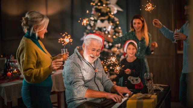 Family Singing Christmas Songs by Piano