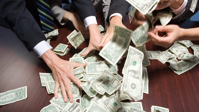 Various People Grabbing for Money