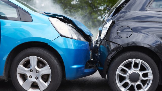 Close Up Of Two Cars Damaged In Road Traffic Accident