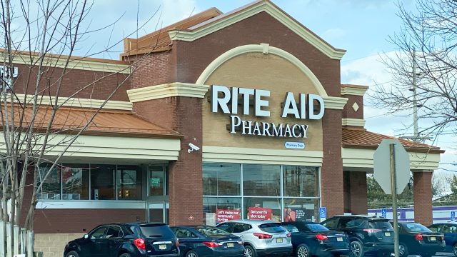 A Rite Aid storefront with cars in the parking lot