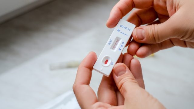 patient holding positive covid test