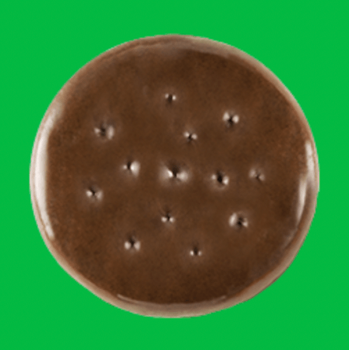 A Girl Scout Thin Mint cookie against a green background