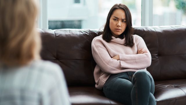Grumpy Woman Folding Arms on Couch