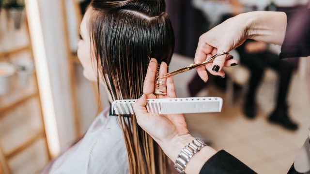 Smiling woman getting a haircut
