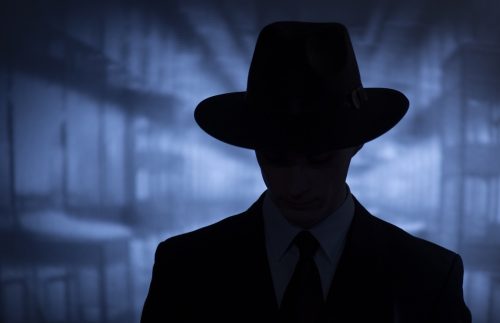 Silhouette of a mysterious man in a vintage style wide brimmed hat