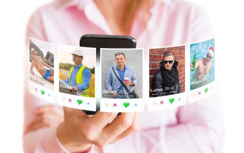 woman viewing multiple male profiles on tinder