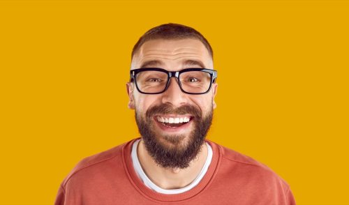 nerdy man laughing at dirty knock knock jokes