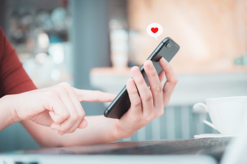 close up of woman sending a flirty text to her crush