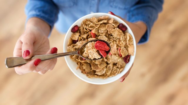 woman eating a bowl of ceereal