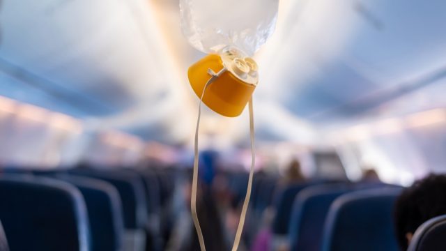oxygen mask hanging from the ceiling on a plane