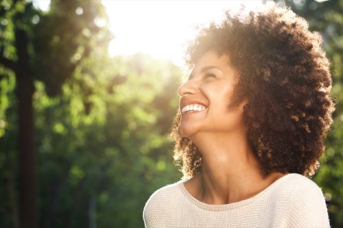 woman smiling in the sunshine