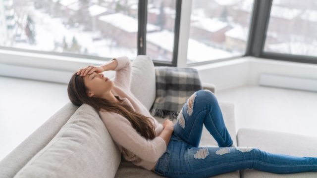 woman sick on the couch