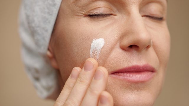 middle-aged woman doing skincare routine