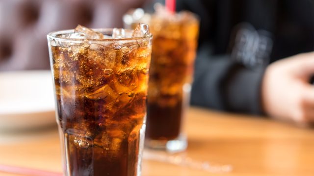 two glasses of soda on a table