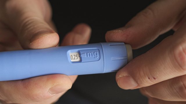 man preparing Semaglutide Ozempic injection control blood sugar levels