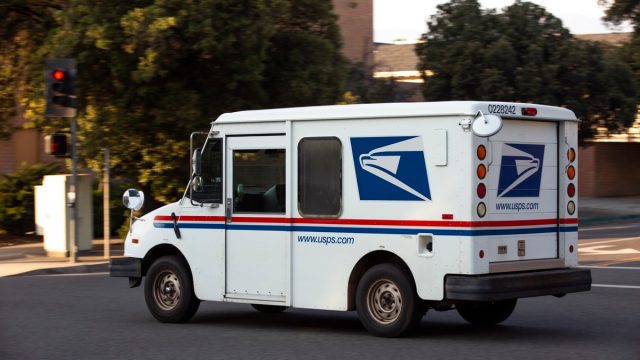Redlands, California / USA - May 9, 2020: A USPS (United States Parcel Service) mail truck leaves for a delivery.