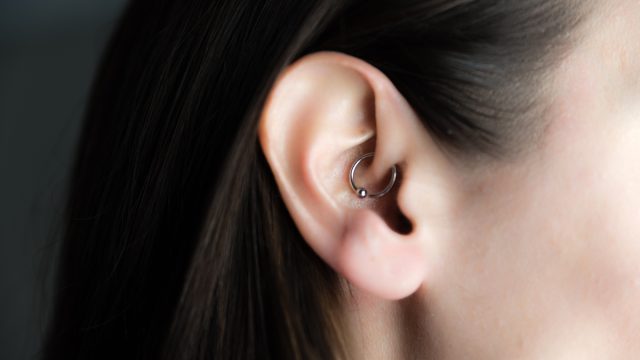 Brunette woman with daith piercing in her ear