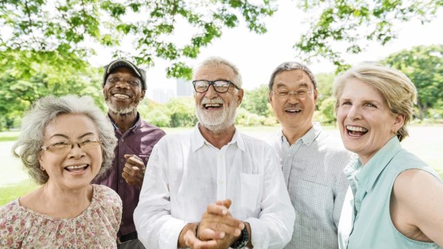 Group of mature friends smiling outside