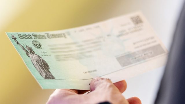 man holding tax refund in hands