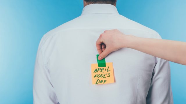woman pulling a harmless april fools prank on her co-worker