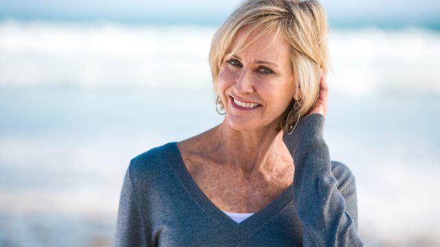Mature woman blonde hair blue sweater