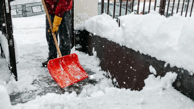 Man with snow shovel