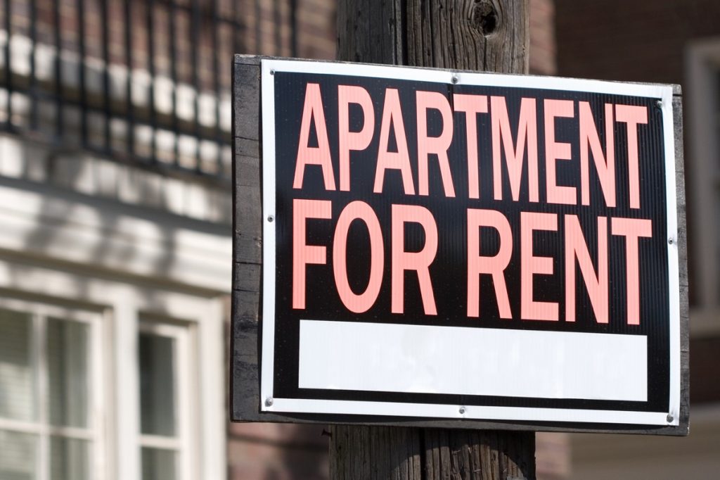 "Apartment for Rent" sign on telephone pole