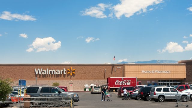 Albuquerque, New Mexico, USA - June 27, 2011: People with shopping carts on the parking lot of the North West Albuquerque Walmart Super-center. Coca-Cola delivery truck parked in front of the store. Picture taken midday.