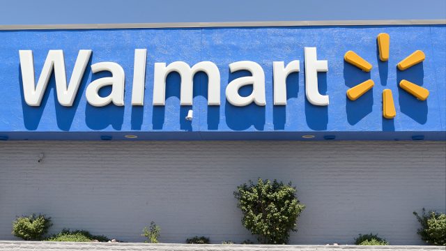 Close up of the Walmart logo on a storefront on a sunny day