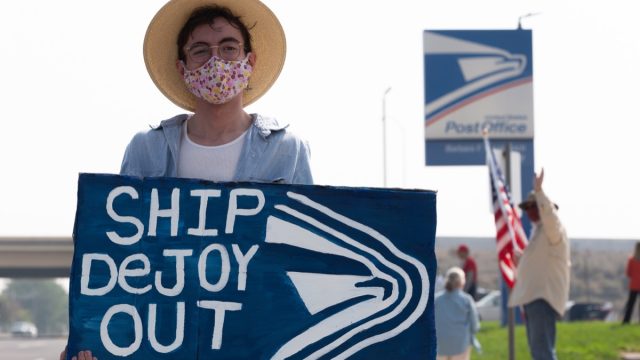 Reno, Nevada / USA – August 22 2020: Protesters gather outside of a local post office to voice their concern about the USPS’s ability to receive mail in ballots efficiently for the upcoming election.