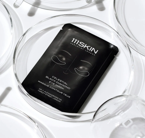 111Skin Celestial Black Diamond Eye Mask packaging on clear dishes