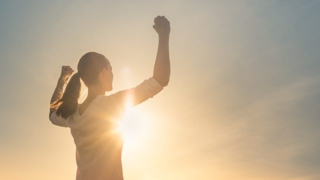 woman looking triumphant in the sunshine