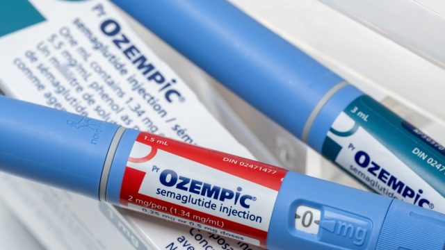 A close up of two Ozempic injectors on top of a product box