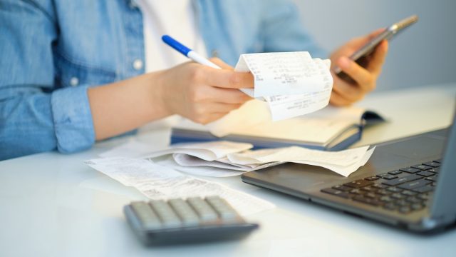 woman filing taxes looking at receipts