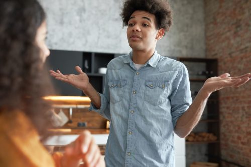 young man shrugging in conversation