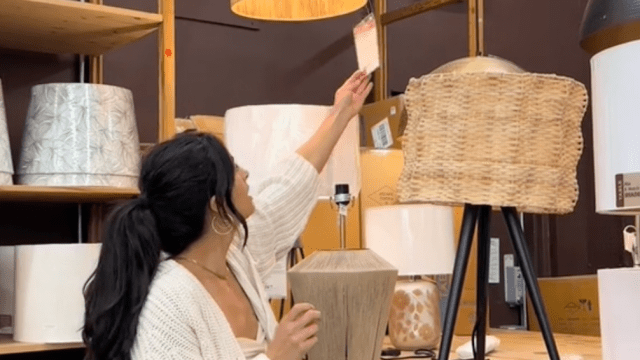 Young woman looking at lamps at a World Market store