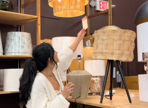 Young woman looking at lamps at a World Market store