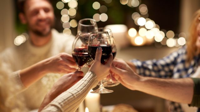 closeup of friends toasting with wine