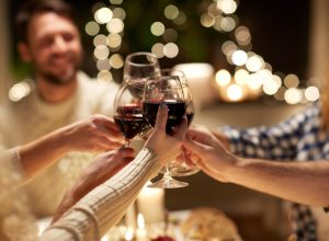 closeup of friends toasting with wine