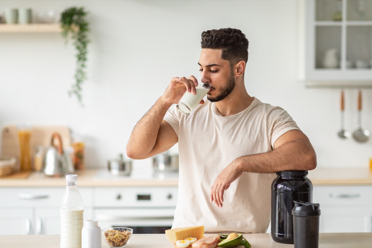 Youn man drinking protein smoothie for muscle gain and weight loss