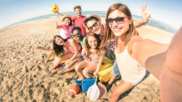 group of friends taking a selfie at the beach
